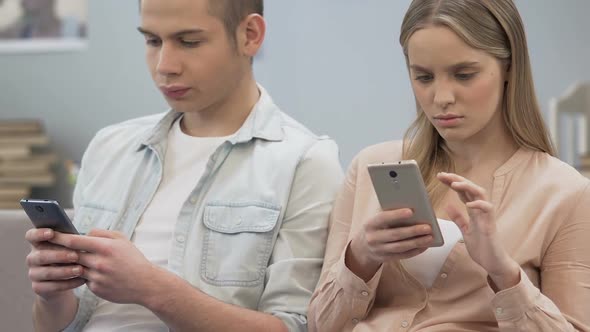 Girl and Boy Spending Time Online on Smartphones, Silence Problem, Bad Habit