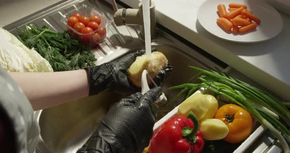 Peeling Potato In A Sink With Fresh Vegetables In Slow Motion