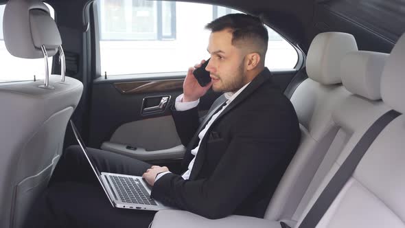 Elegant Young Man with Beard Talking on Phone, Process of Working in Car