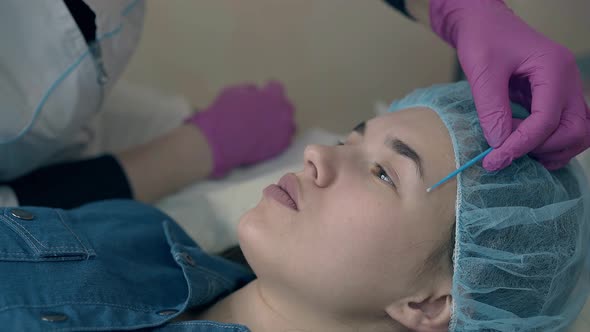 Master Brushes Girl Brow Before Applying Permanent Makeup