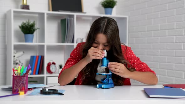 Child Using Microscope to Study at School Education