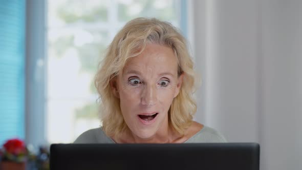 Happy Surprised Aged Woman Using Laptop Receiving Awesome News