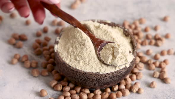 Bowl of raw chickpea flour and beans with a spoon