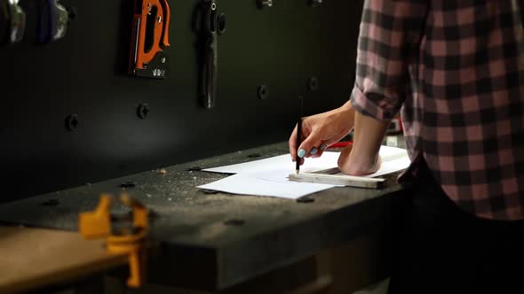 Female Interior Designer Working on Drawings Woman Architect Draws with Ruler Plan