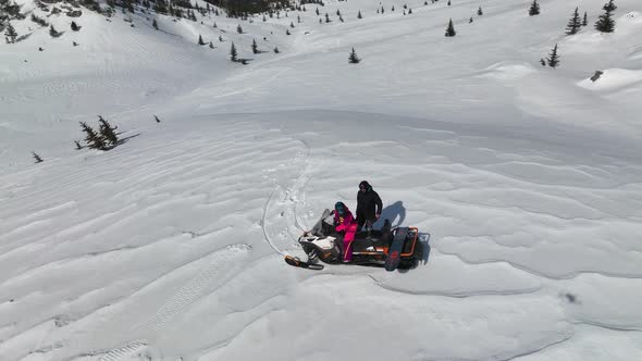 Snowmobile high in the mountains aerial view 4 K