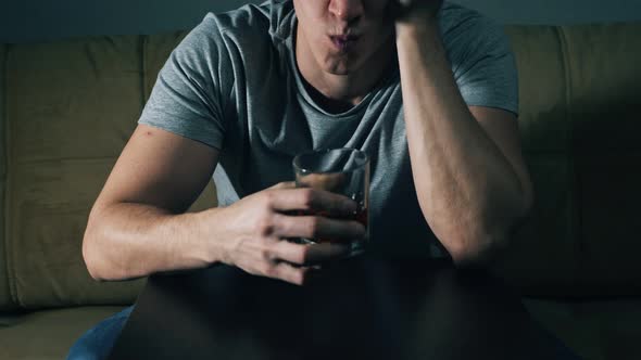 Unrecognizable Man Drinks Whiskey From Glass