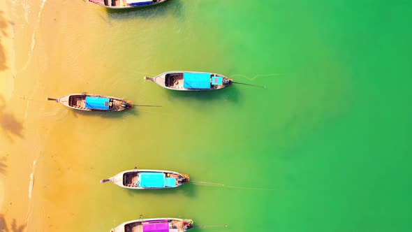 Aerial top view over sandy beach with turquoise water