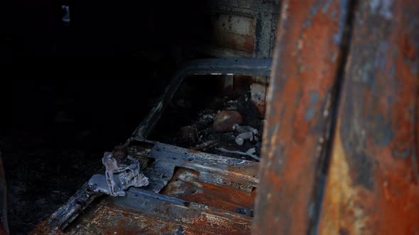 Bombed Burnt Car Interior Closeup with Live Camera Moving Left and Right