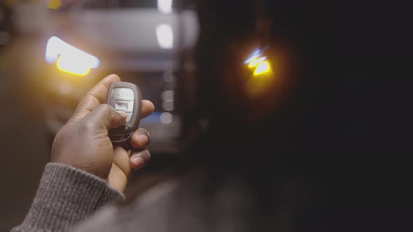 Close Up Black Man Holding Car Keys and Unlocking the Car