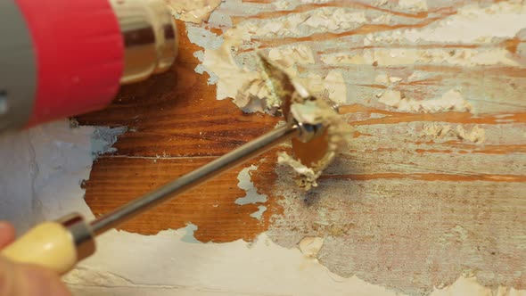 Easy cheap restoration of wooden door window. Restorer carpenter peels off paint from painted timber