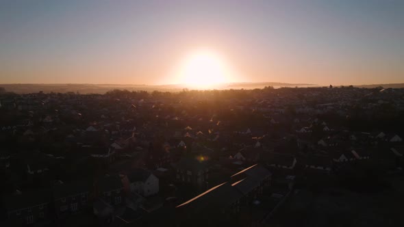 AERIAL: Sunset pan out over small sub urban housing estate, Swansea, 4k Drone