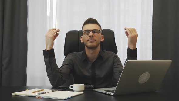 Businessman sitting at his office desk in dzen position. Corporate business concept