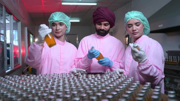 Product quality control staff at the fruit juice production line Perform product quality checks