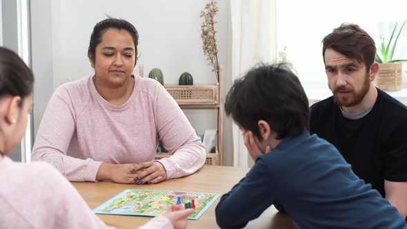 Young Family Playing with Board Game