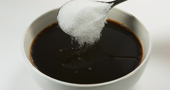 Sugar Falling into Bowl of Coffee, Slow Motion 4K