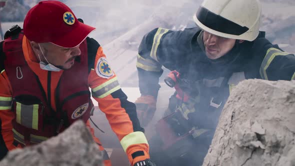 Paramedic and Rescuer Discussing Rubble