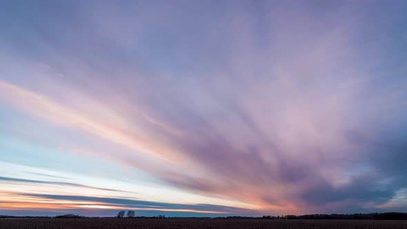 Colorful sunset clouds in the field time lapse alt