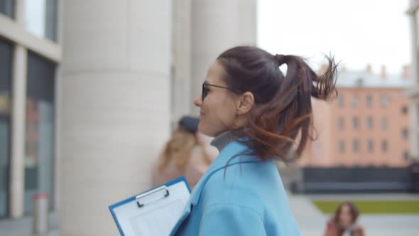 Young Businesswoman Walking in Residential Building Hurrying To Work