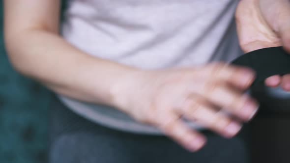 Person Cleans Black Leather Fabric Strip in Hands Closeup