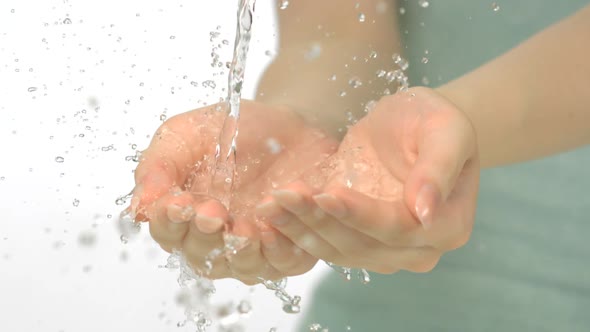 Water pouring in woman's hands, Slow Motion