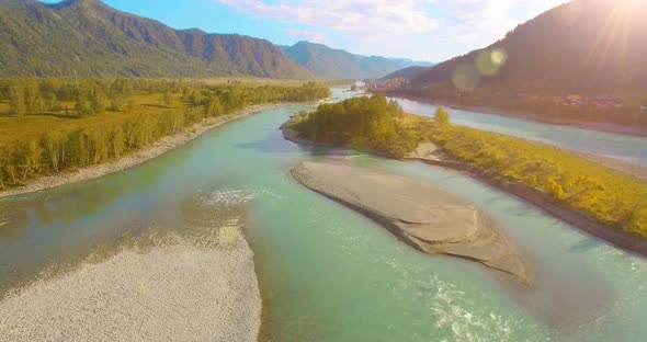 Low Altitude Flight Over Fresh Fast Mountain River with Rocks at Sunny Summer Morning