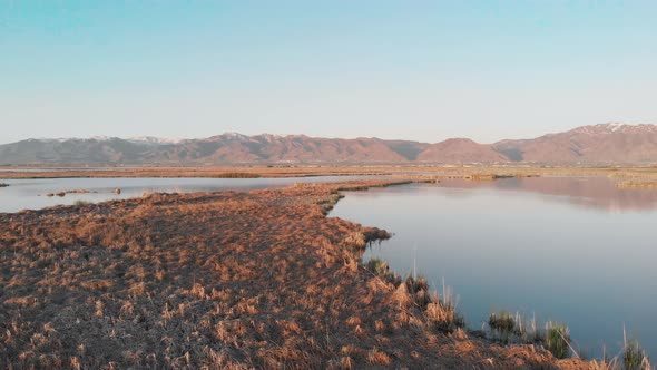 Utah Marsh at Sunset Reflecting the Mountains 4K Drone Aerial View
