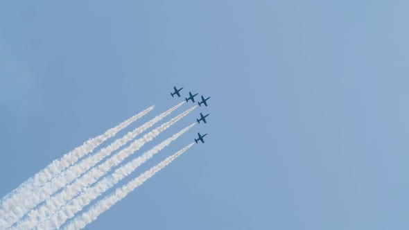 Aircrafts Similar To Crosses Fly and Do Stunts with Smoke From Special Cylinders