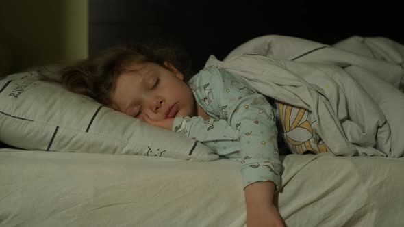 Cute Little Kid Girl Sleeping Well Alone in Bed