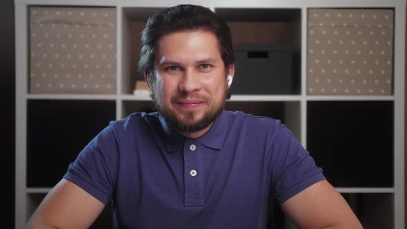 Young business man make conference call at home, smiling male manager talk look at camera.