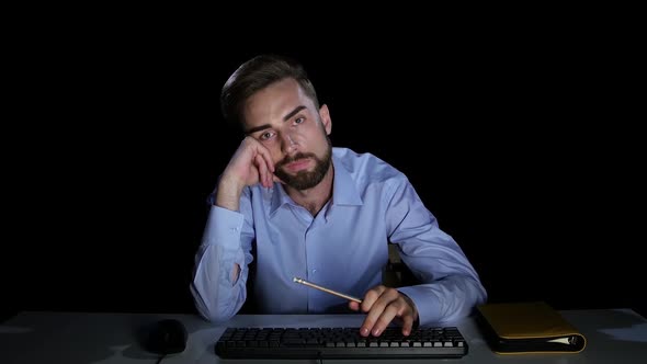 Businessman with Indifference Looking at a Computer Screen. Dark Studio
