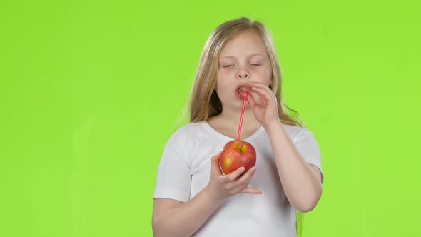 Baby Holds an Apple in Her Hands and Drinks Juice From It, Green Screen