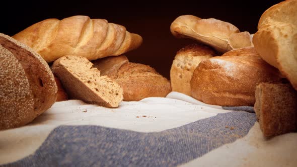 Assortment of Fresh Bread on Tablecloth Zoom in Video