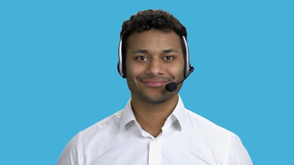 Smiling Call Center Operator on Blue Background.