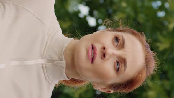 Vertical Screen Close-up female stops to breathe while jogging.