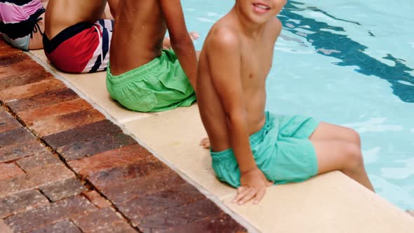 Portrait of students relaxing at poolside