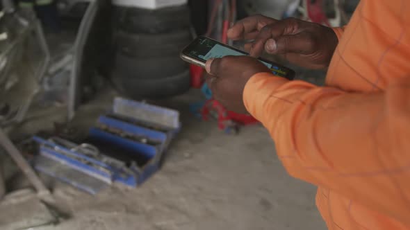 African man using phone at work