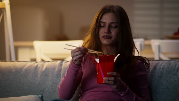 Happy Confident Woman Eating Chinese Food From Restaurant Delivery and Watching Tv Spending Evening