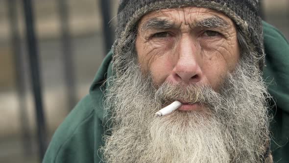 old homeless smoking: closeup portrait of a real homeless