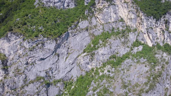 Aerial View. The Frame Is a Huge Sheer Cliff. Beautiful Mountain Landscape with Stone and Vegetation