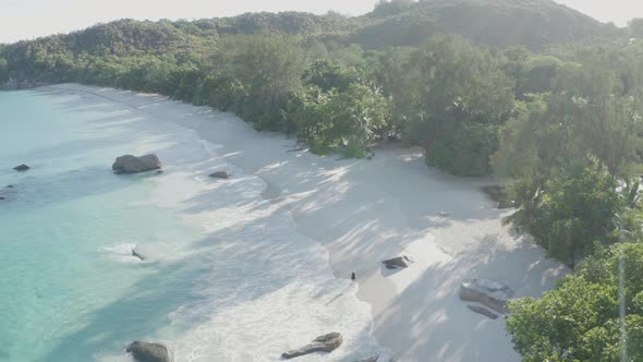 Aerial view of a person walking on the beach of Anse Lazio, Seychelles.