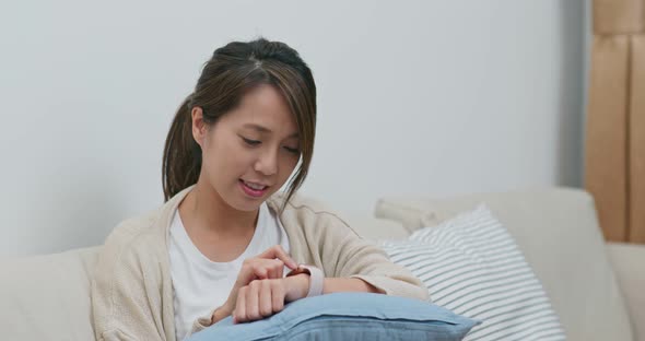 Woman use of smart watch at home