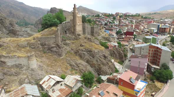 Old Fortress Walls and Watchtower of Castle Behind the Houses in the Small Town