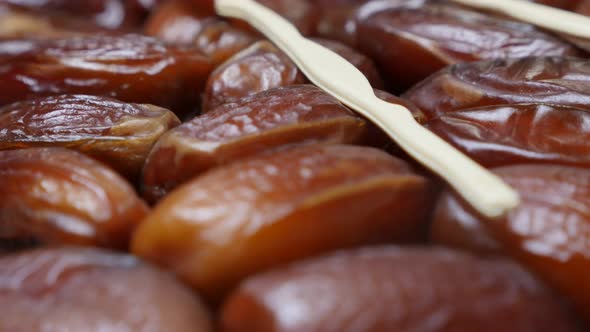 Palm dates fruit packed in the original package close-up 4K 2160p 30fps UltraHD tilting footage - Ph