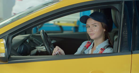 Portrait of Car Female Mechanic in a Car, with Keys in Her Hands. Concept: Repair of Machines, Fault