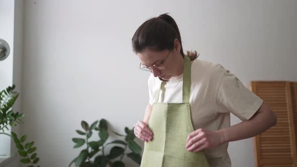 Professional Florist Wears an Apron in a Flower Shop