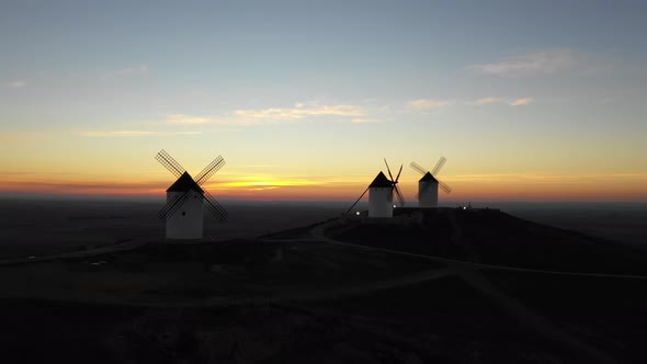 Aerial view of windmills in the countryside in Spain at sunrise