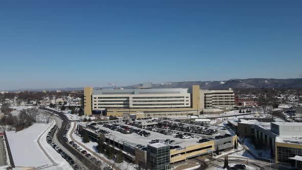 Bright sunny day in winter looking over a large business complex with parking ramp.