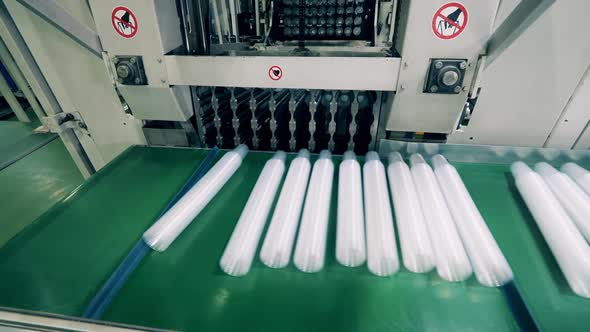 Plastic Cups Being Automatically Placed Onto a Conveyor