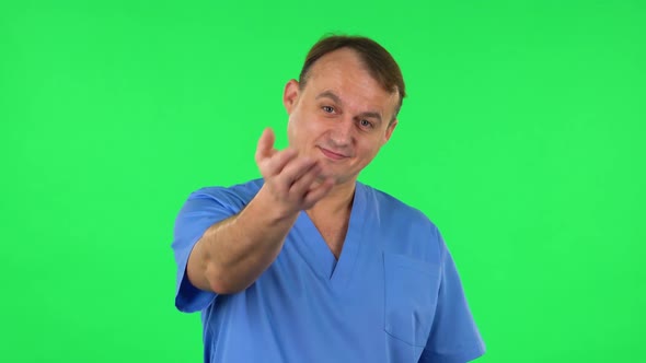 Medical Man Waving Hand and Showing Gesture Come Here. Green Screen