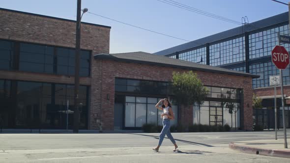 Asian Woman Crossing City Road with Coffe Cup